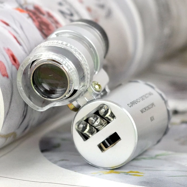 Compact portable microscope with LED and UV lamp for detailed inspection