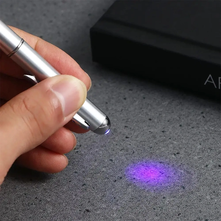 Writing instrument with ink visible only under ultraviolet light