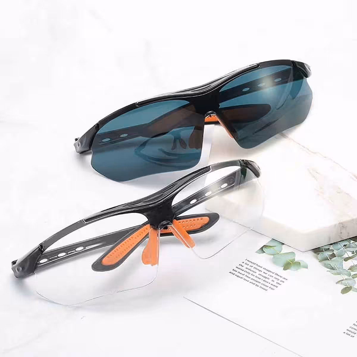 Top-down view of two pairs of clear and smoked glasses
